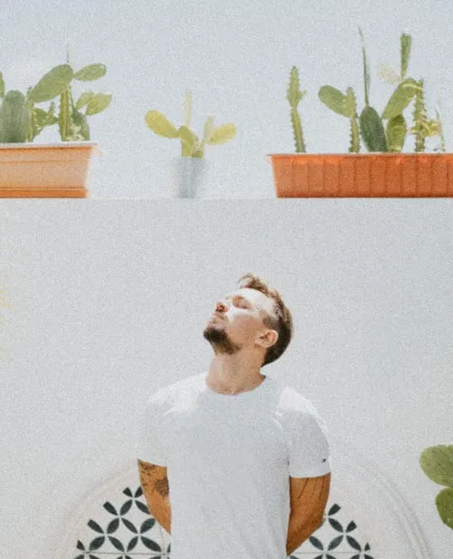 photo of gaston garcia staring at the sun with cactus behind